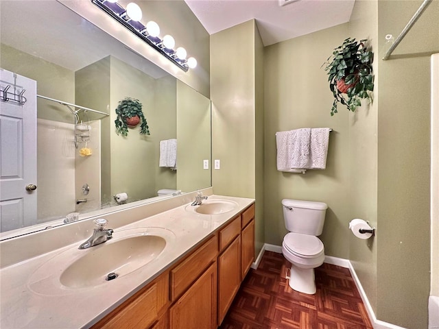 bathroom with vanity, walk in shower, parquet floors, and toilet