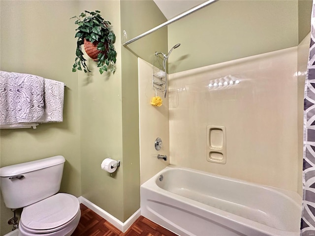 bathroom featuring shower / bath combination, parquet flooring, and toilet