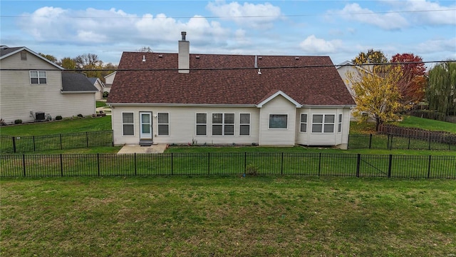 back of house with a lawn