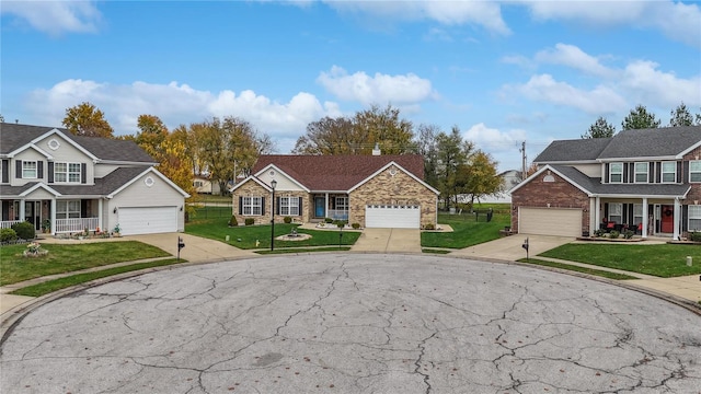 view of front of property featuring a garage, a porch, and a front lawn