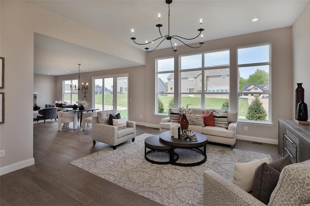 living room featuring dark hardwood / wood-style flooring and a notable chandelier