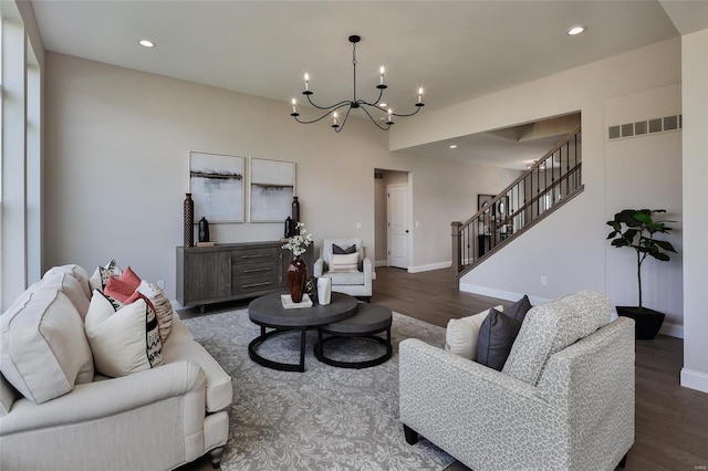 living room featuring dark hardwood / wood-style floors and a chandelier