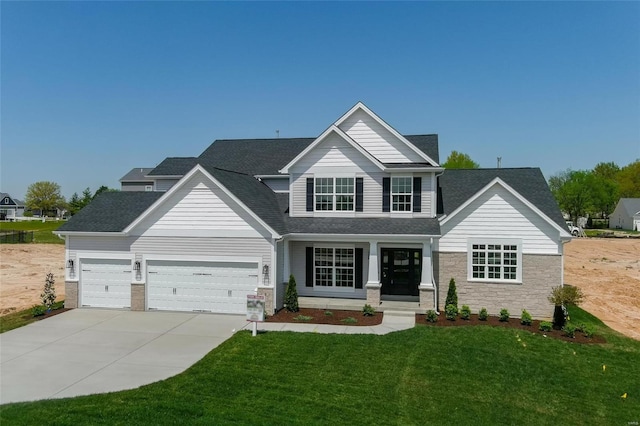 view of front of property featuring a garage and a front lawn