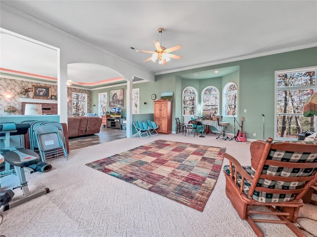 interior space with crown molding, ceiling fan, and carpet floors