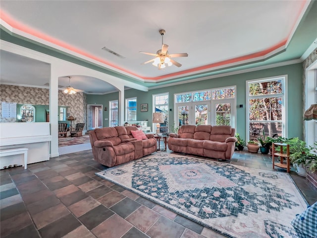 living room with ceiling fan and crown molding