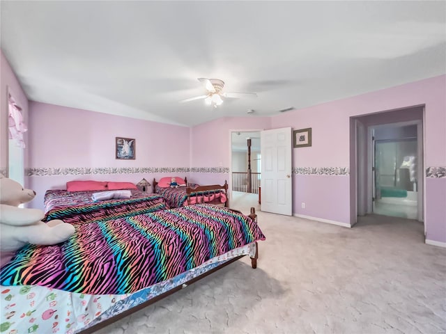 carpeted bedroom with ceiling fan and ensuite bath