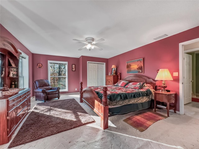 bedroom featuring a closet, light carpet, and ceiling fan