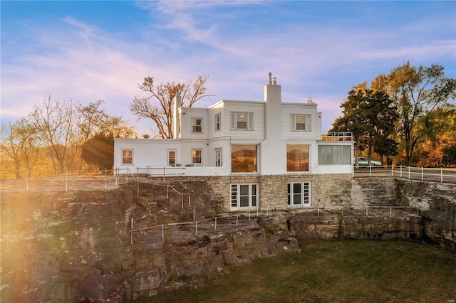 view of back house at dusk