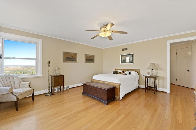 bedroom with ceiling fan, crown molding, and light hardwood / wood-style flooring