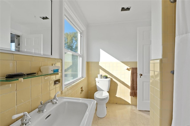 bathroom featuring tile patterned floors, ornamental molding, sink, tile walls, and toilet