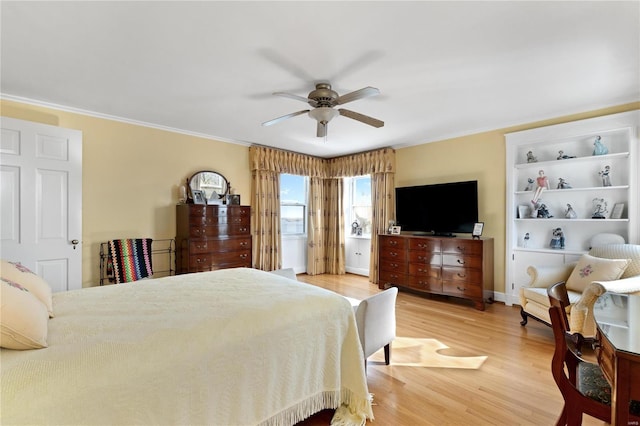 bedroom with ceiling fan, crown molding, and wood-type flooring