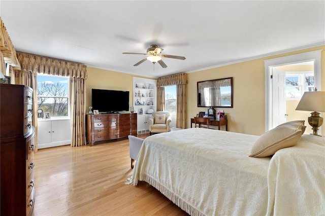 bedroom with multiple windows, ceiling fan, ornamental molding, and light wood-type flooring