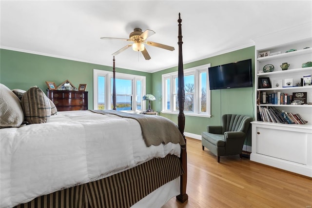 bedroom with ceiling fan, crown molding, and light hardwood / wood-style floors