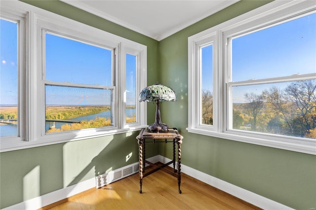 interior space with plenty of natural light and a water view