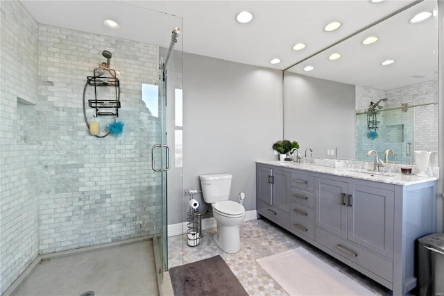 bathroom featuring vanity, toilet, and a shower with shower door