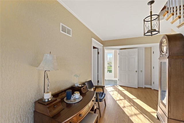 entrance foyer featuring light hardwood / wood-style floors and crown molding