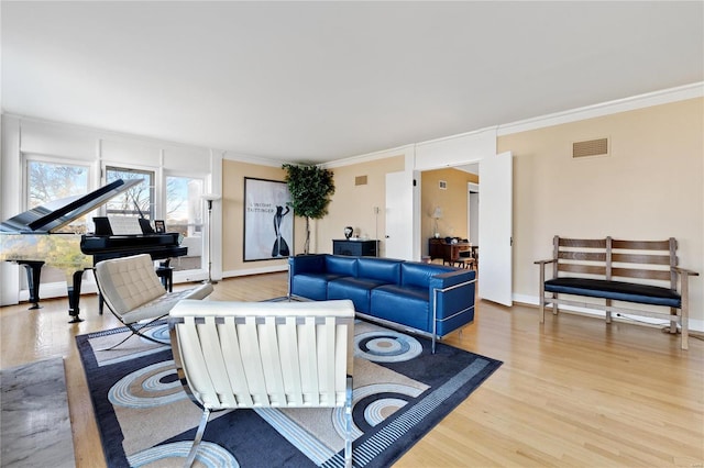 living room with ornamental molding and light wood-type flooring