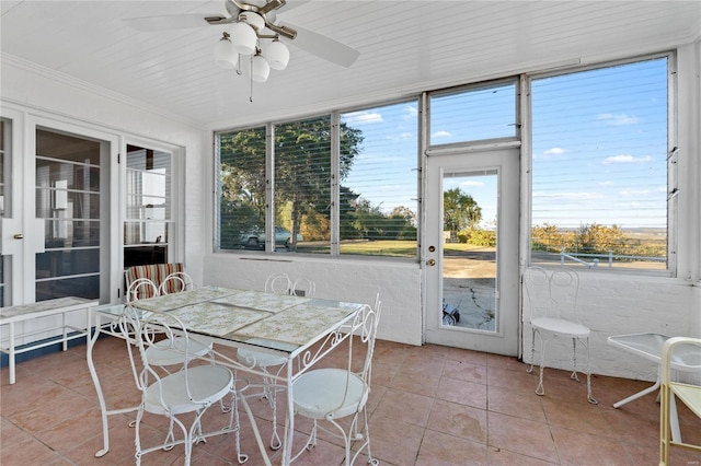 sunroom / solarium featuring ceiling fan