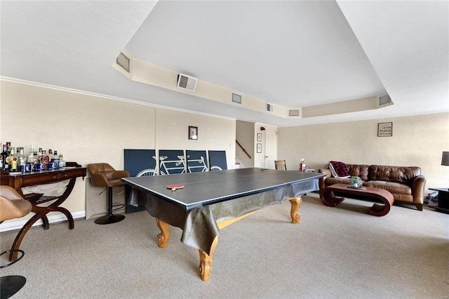 recreation room with carpet flooring and a tray ceiling