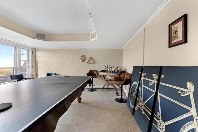 recreation room featuring carpet flooring and crown molding