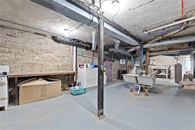 basement with water heater and washer and clothes dryer