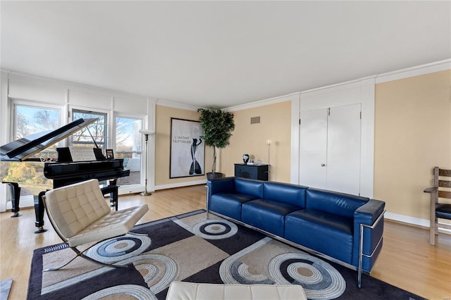 living room featuring light hardwood / wood-style floors and ornamental molding