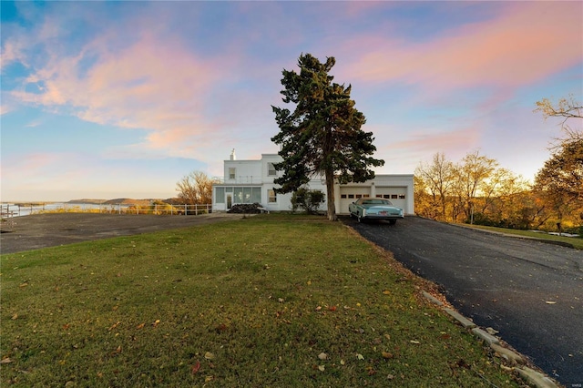 view of front of house featuring a lawn and a garage