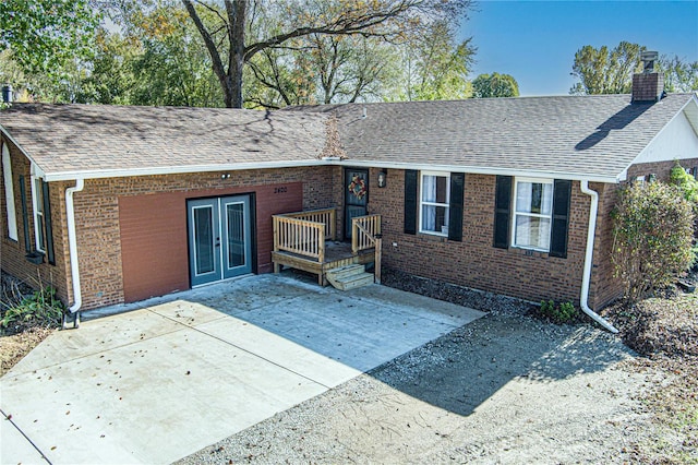 view of front of home featuring a patio and french doors