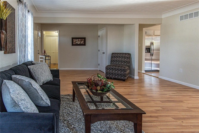 living room featuring hardwood / wood-style floors and ornamental molding