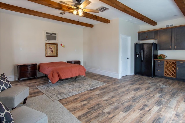 bedroom with dark hardwood / wood-style flooring, black refrigerator with ice dispenser, a wall unit AC, ceiling fan, and beam ceiling