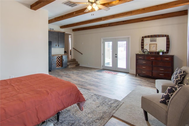 bedroom featuring access to exterior, french doors, ceiling fan, beam ceiling, and light hardwood / wood-style floors