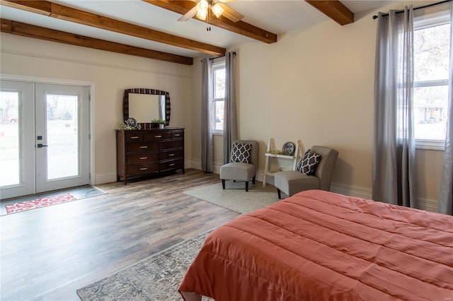 bedroom with beam ceiling, access to exterior, french doors, and multiple windows