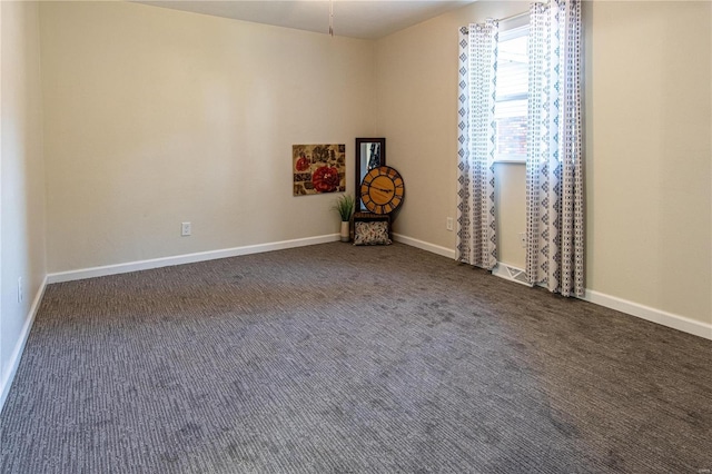 empty room featuring dark carpet