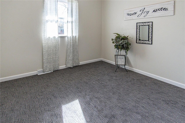 empty room featuring dark colored carpet