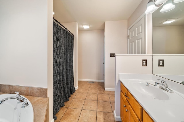 bathroom with tile patterned flooring, vanity, and a tub