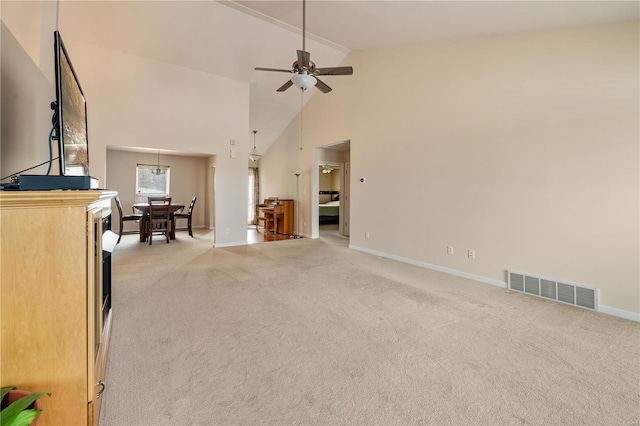 carpeted living room featuring ceiling fan and high vaulted ceiling