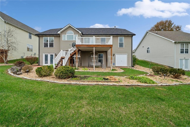 back of property featuring a yard and a wooden deck