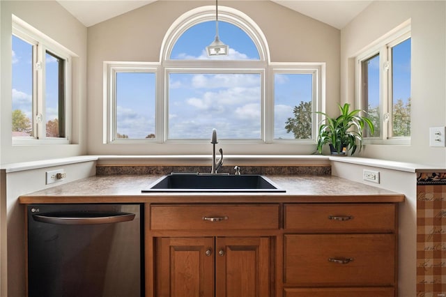 kitchen with dishwasher, sink, vaulted ceiling, a wealth of natural light, and decorative light fixtures