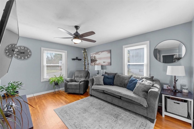 living room with wood-type flooring and ceiling fan