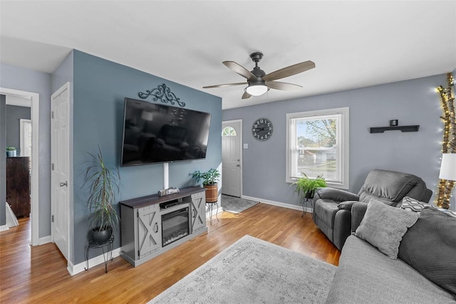 living room with wood-type flooring and ceiling fan