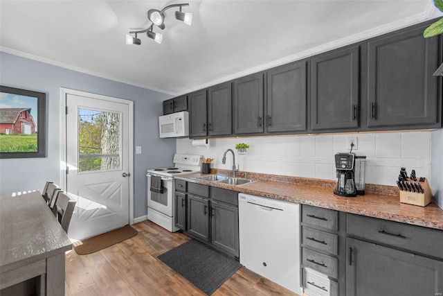 kitchen featuring sink, dark hardwood / wood-style floors, backsplash, white appliances, and crown molding