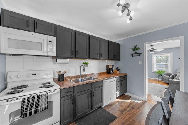 kitchen featuring sink, ornamental molding, backsplash, white appliances, and dark hardwood / wood-style flooring