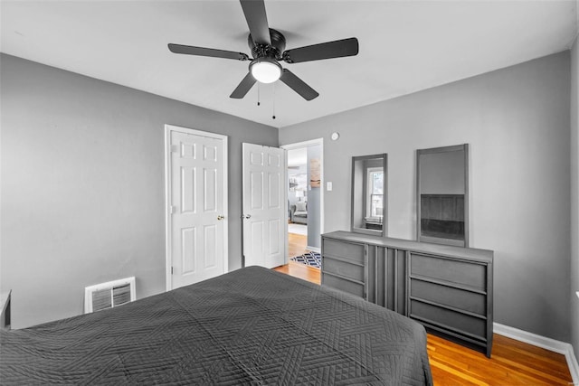 bedroom featuring light hardwood / wood-style floors and ceiling fan