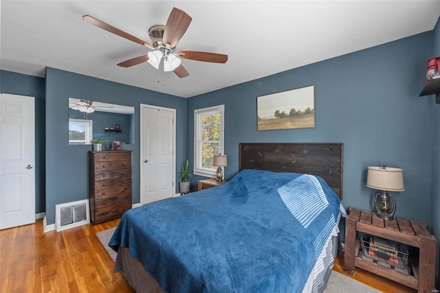 bedroom featuring hardwood / wood-style flooring and ceiling fan