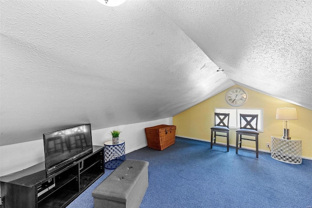 living area with a textured ceiling and vaulted ceiling