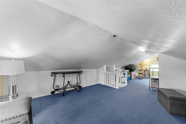 bonus room with lofted ceiling, a textured ceiling, and carpet flooring