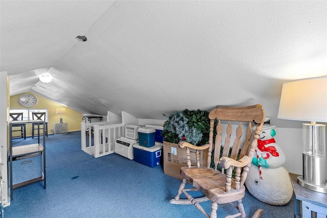 additional living space with a textured ceiling, vaulted ceiling, and dark carpet