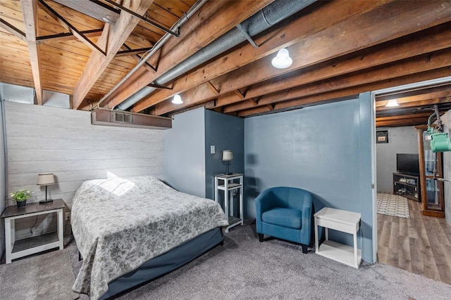 bedroom featuring wood-type flooring and beamed ceiling