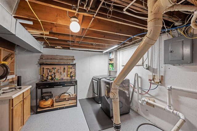 basement featuring electric panel and independent washer and dryer