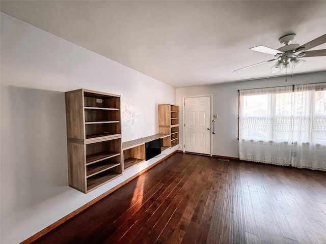 empty room with dark wood-type flooring and ceiling fan